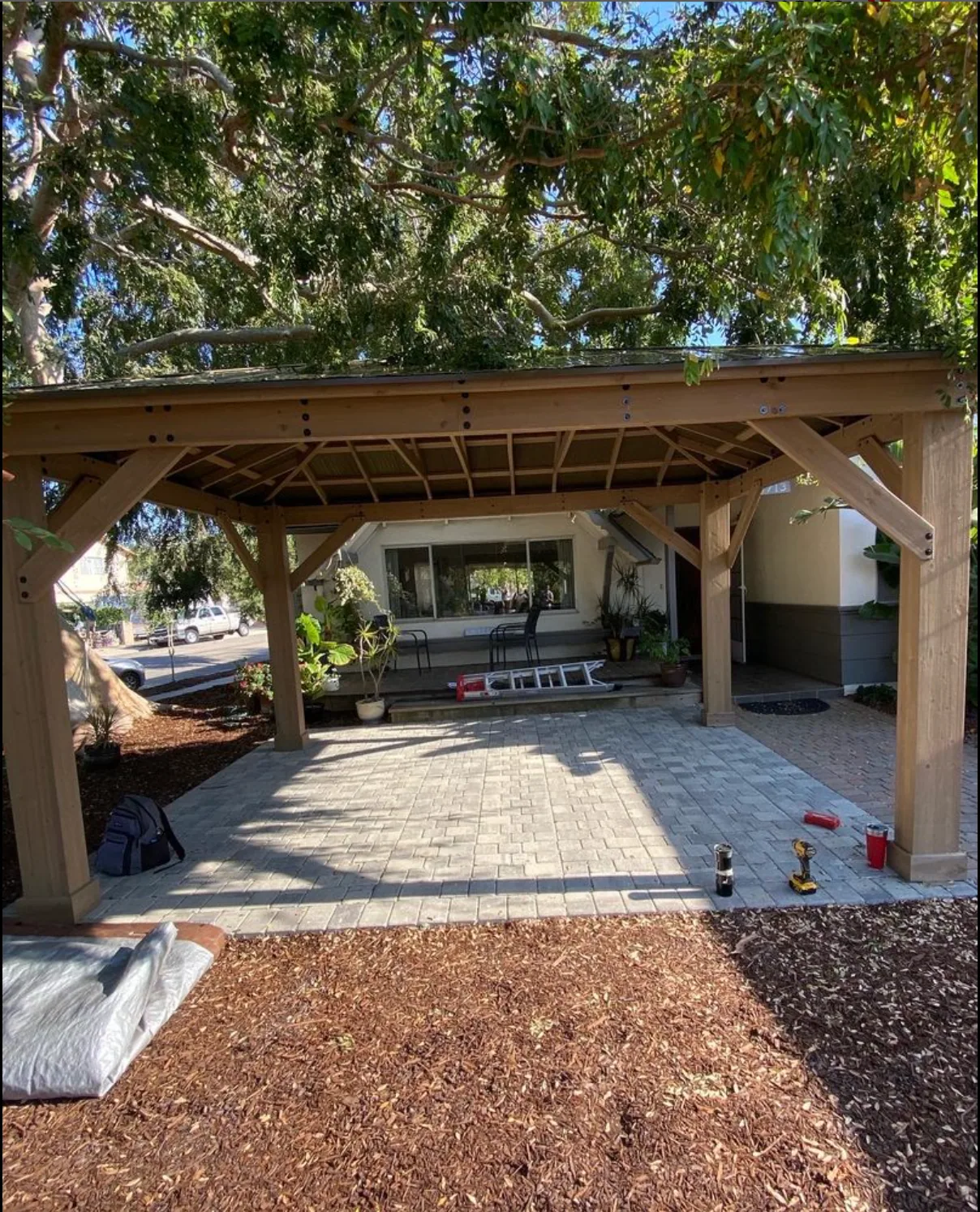 Timber patio cover over a paved outdoor living area